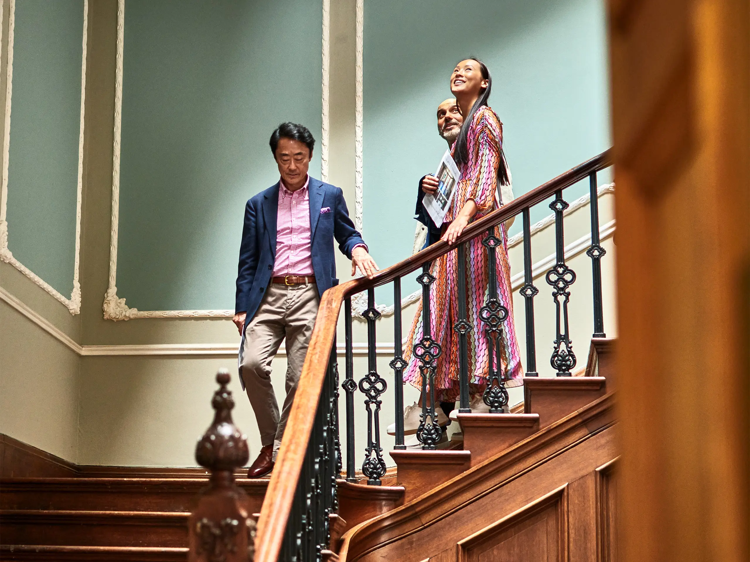 Estate-agent-showing-wealthy-couple-spacious-house