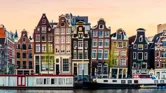 A surface level sunrise view of Amsterdam at dawn
