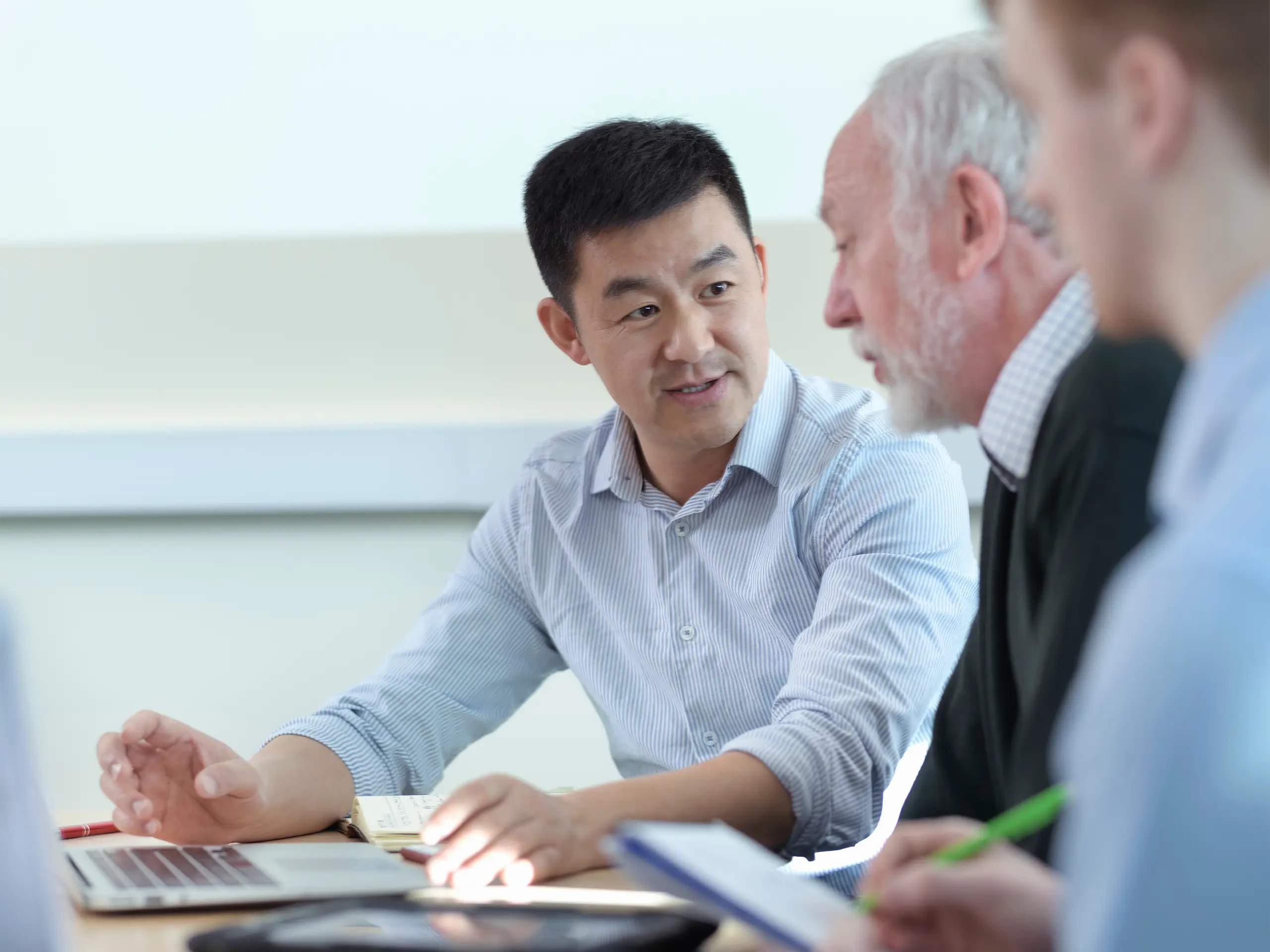 younger-and-older-scientists-discussing-pharmaceutical-science-project-in-meeting-room