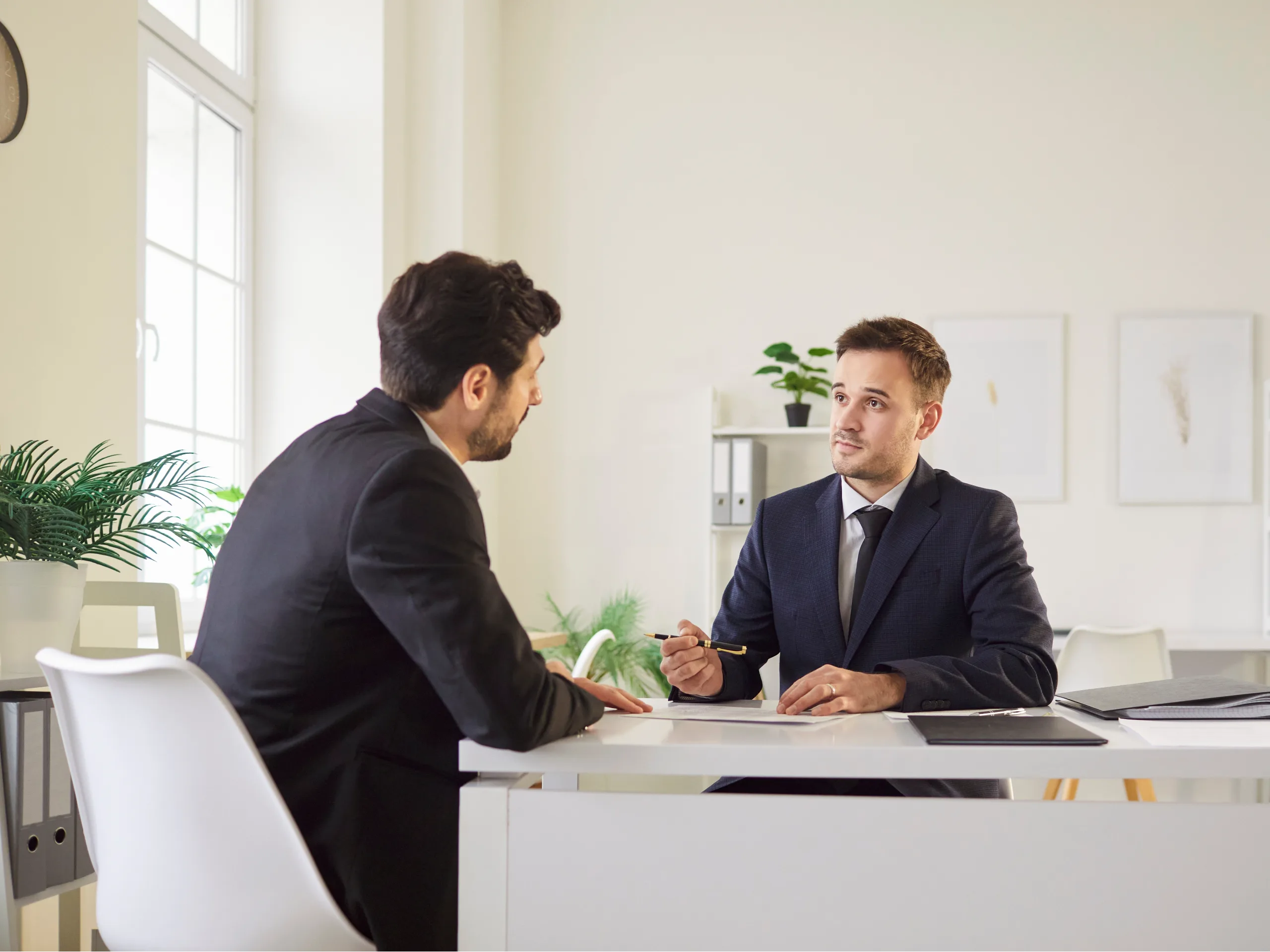 Men in a light-filled office