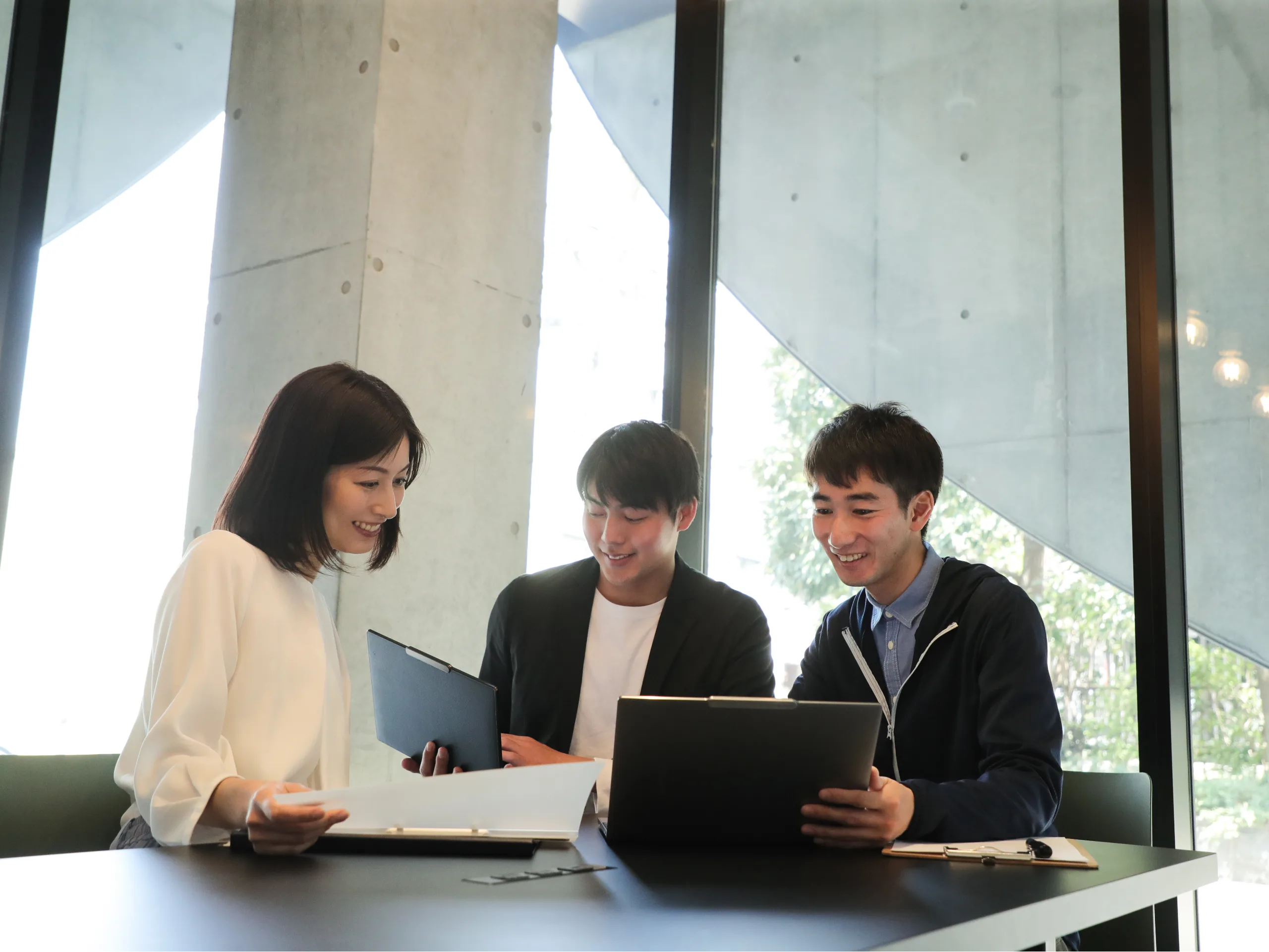 Team of colleagues looking at laptops
